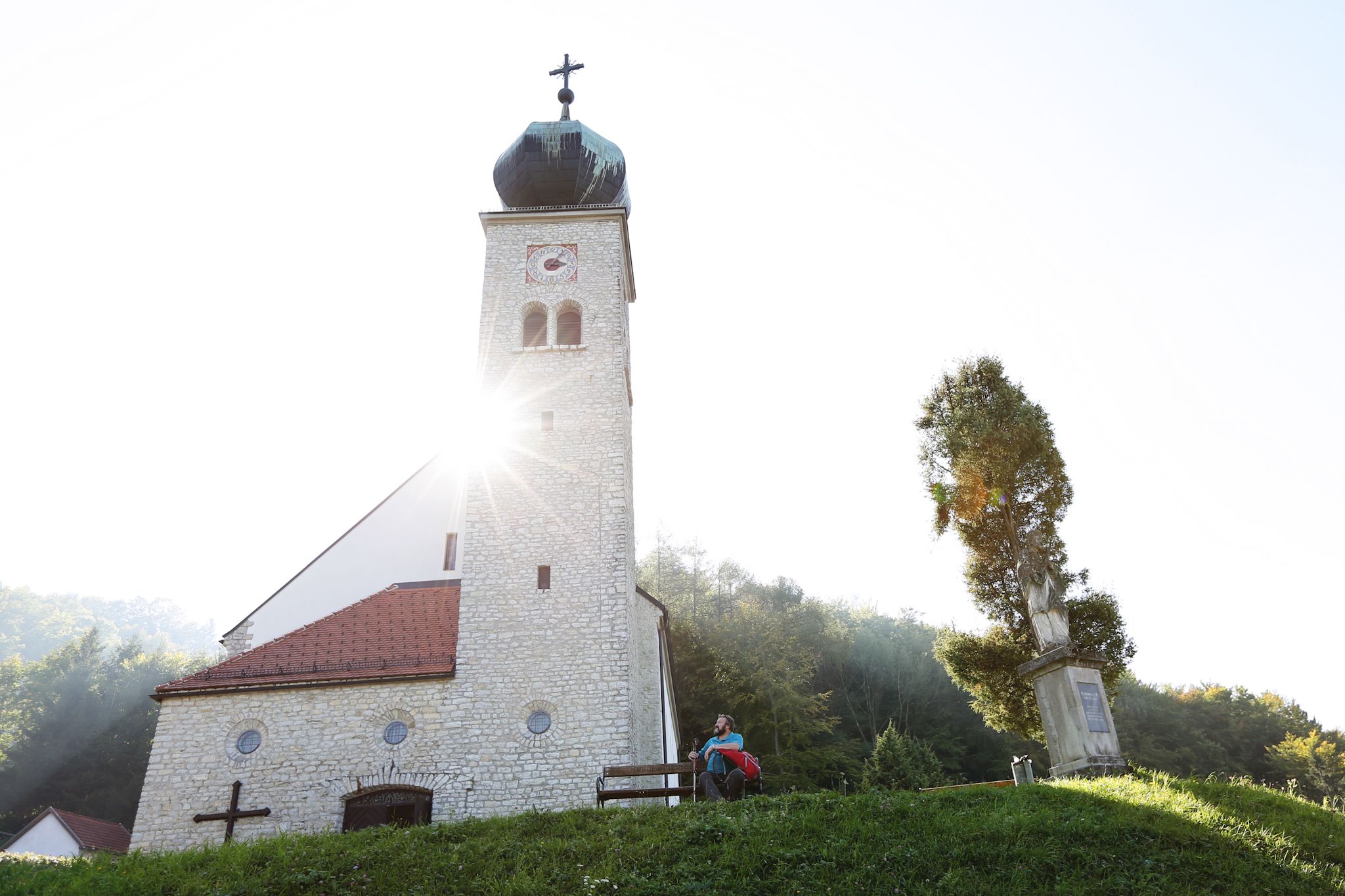 Poutní kostel Maria Schnee se slunečními paprsky ve věži kostela.