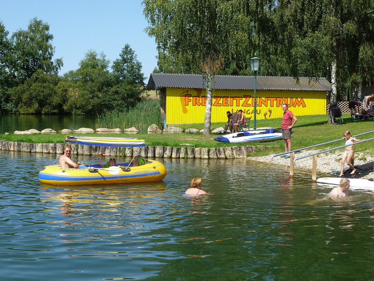 Lidé si v Bergwerksee Langau užívají volnočasové aktivity.
