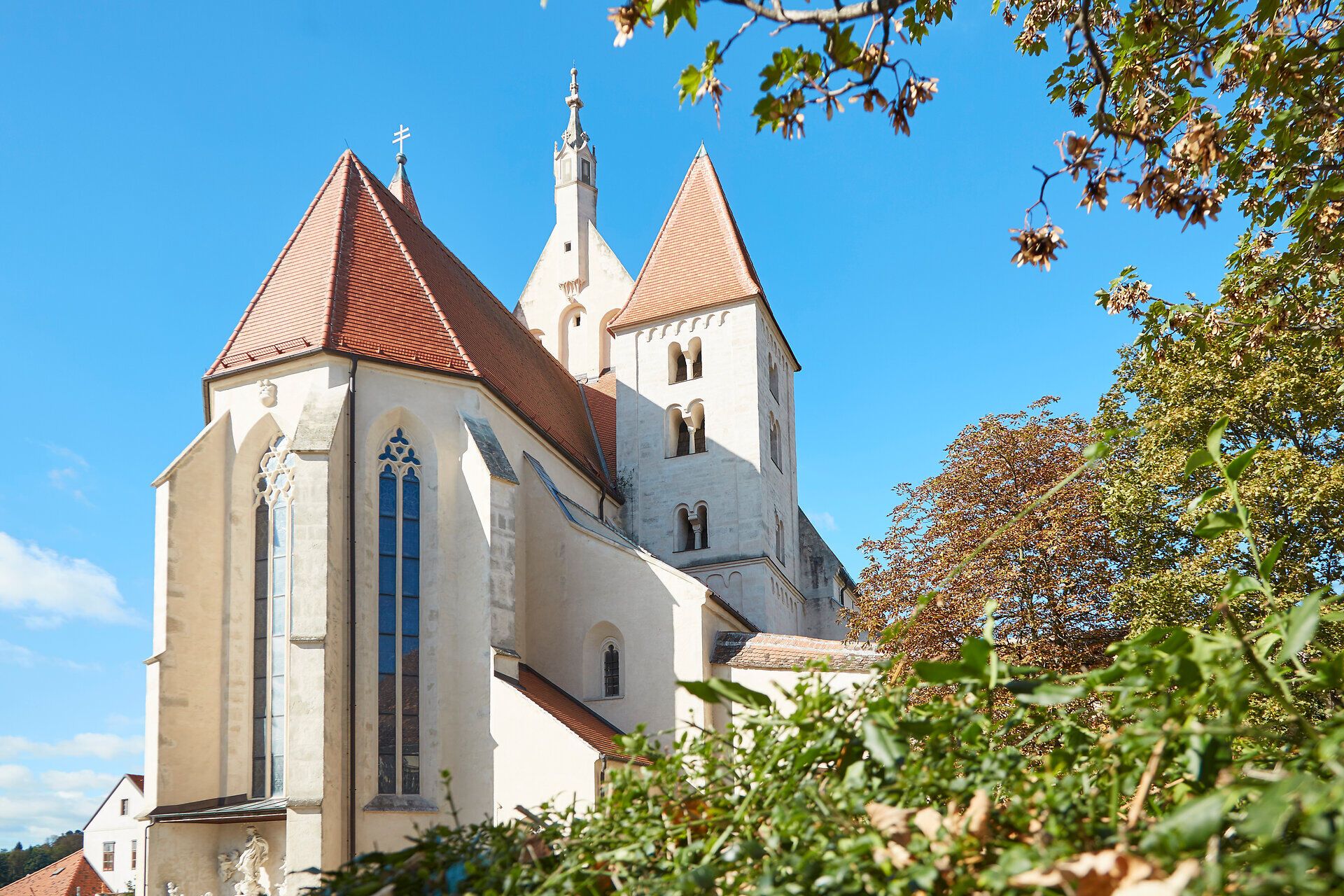 Kostel v Eggenburgu s červenými střechami a modrou oblohou.