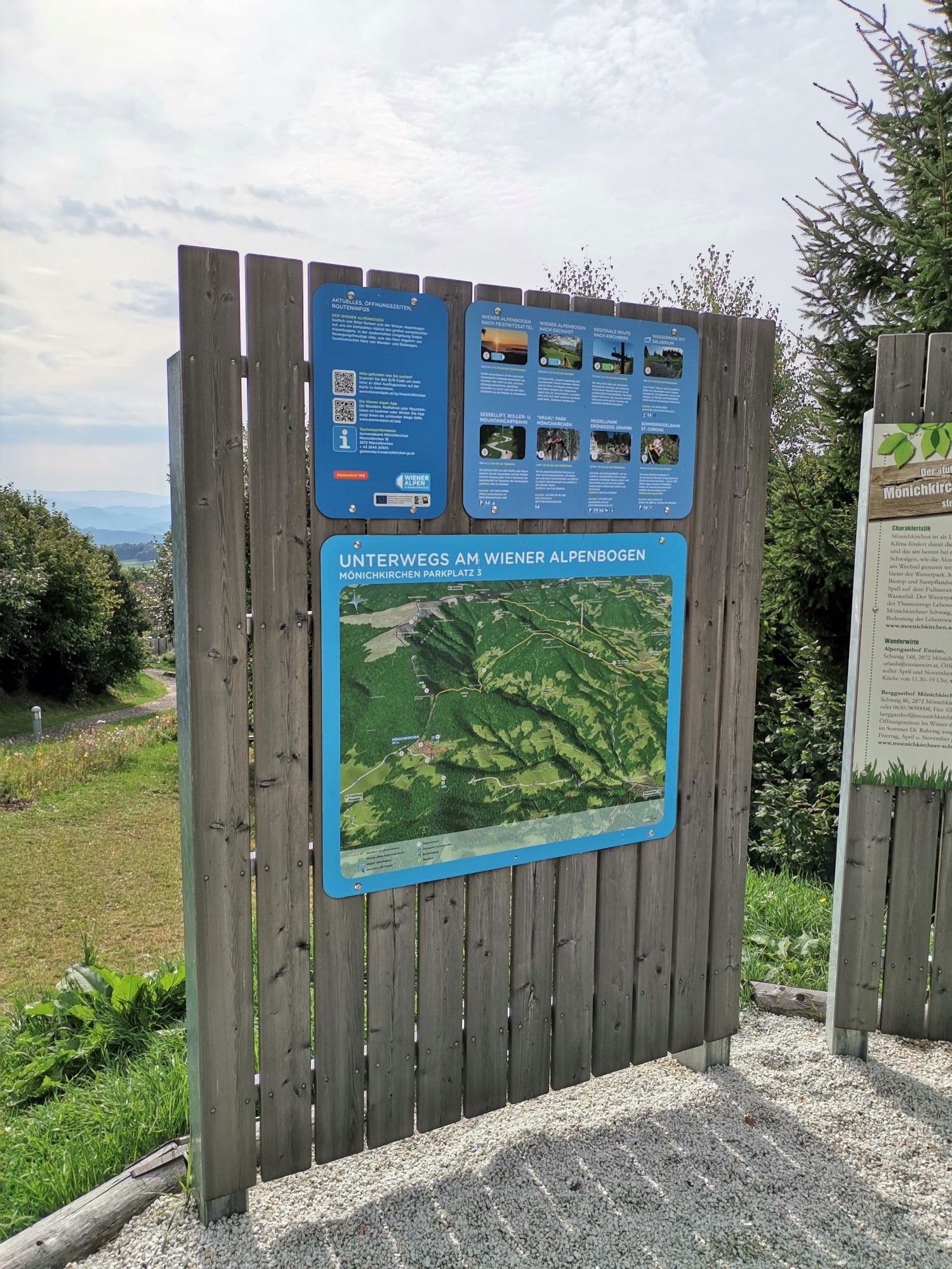 Informační tabule u Wiener Alpenbogenu - oblouku Vídeňských Alp (dálková turistická trasa) s mapou a texty.