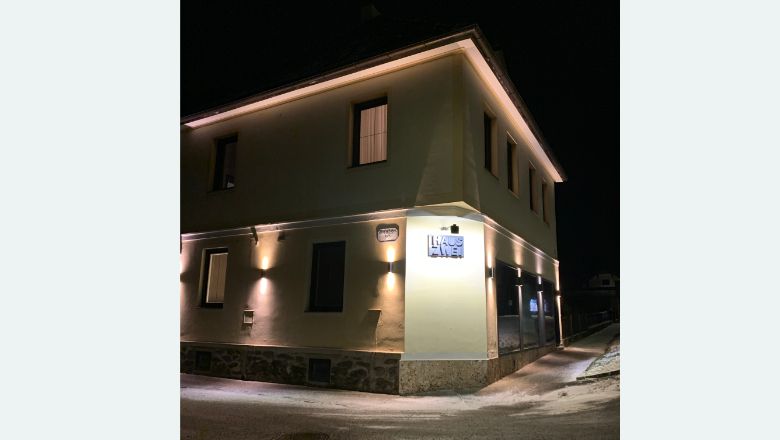 Noční osvětlení budovy s nápisem "Haus Zwei".