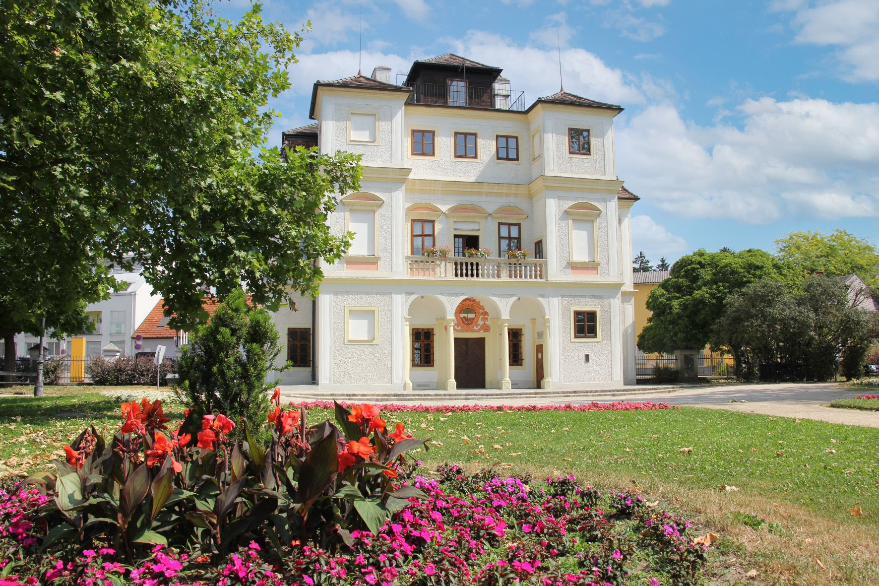 Belvedereschlössl ve Stockerau s rozkvetlými květinami v popředí.