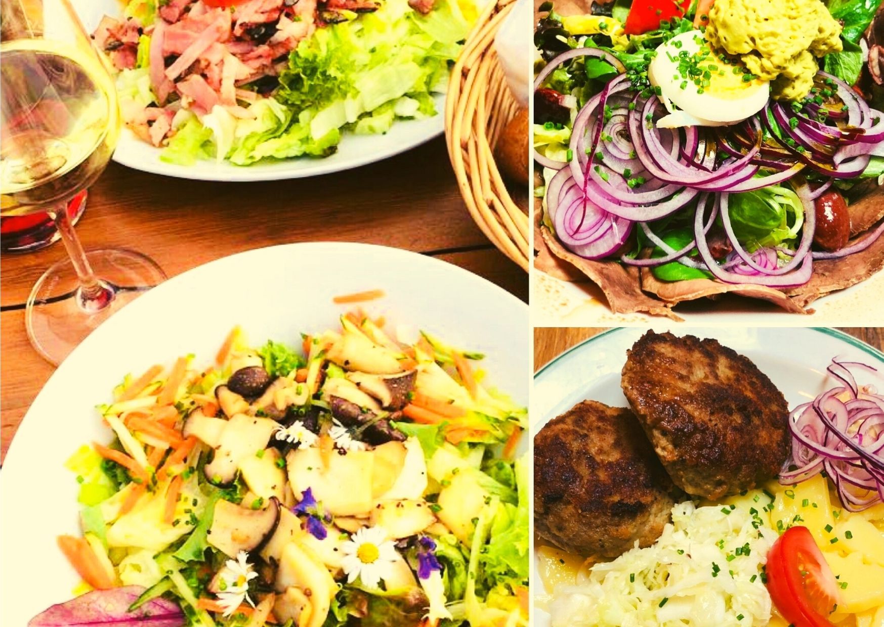 Různé talíře se saláty, masem a sklenkou bílého vína.